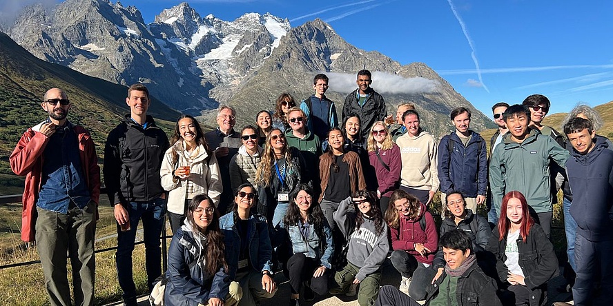 Group photo of 30 students in front of the French Alps.