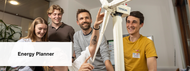 Group of people looking at a Lego wind power plant.