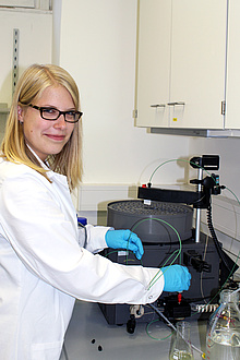 Researcher in front of laboratory device