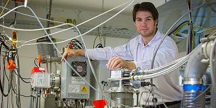 Andreas Hauser is standing inside his laboratory.