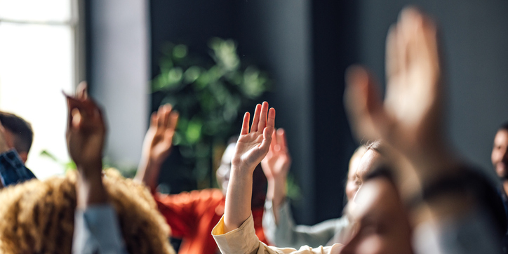 People raise their hands in the air